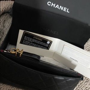 Black with red Chanel wallet.
